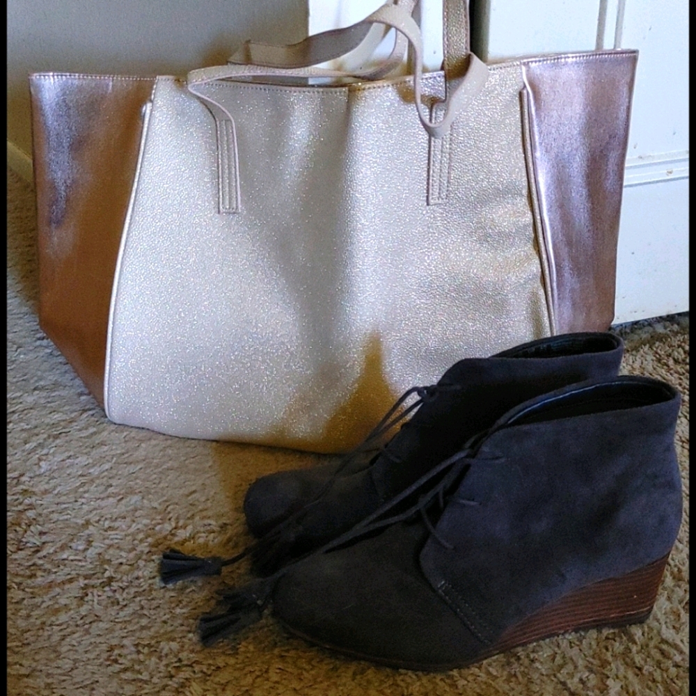 A cute dark brown pair of boot shoes with tassels